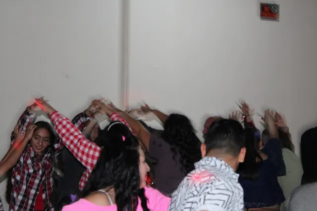 Hands in the air on a crowded dance floor