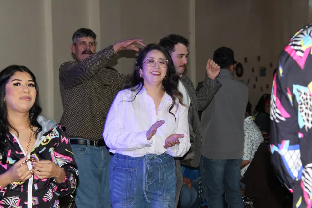 A crowd dancing under party lights