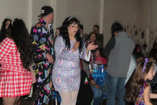 Guests laughing and dancing together at a party